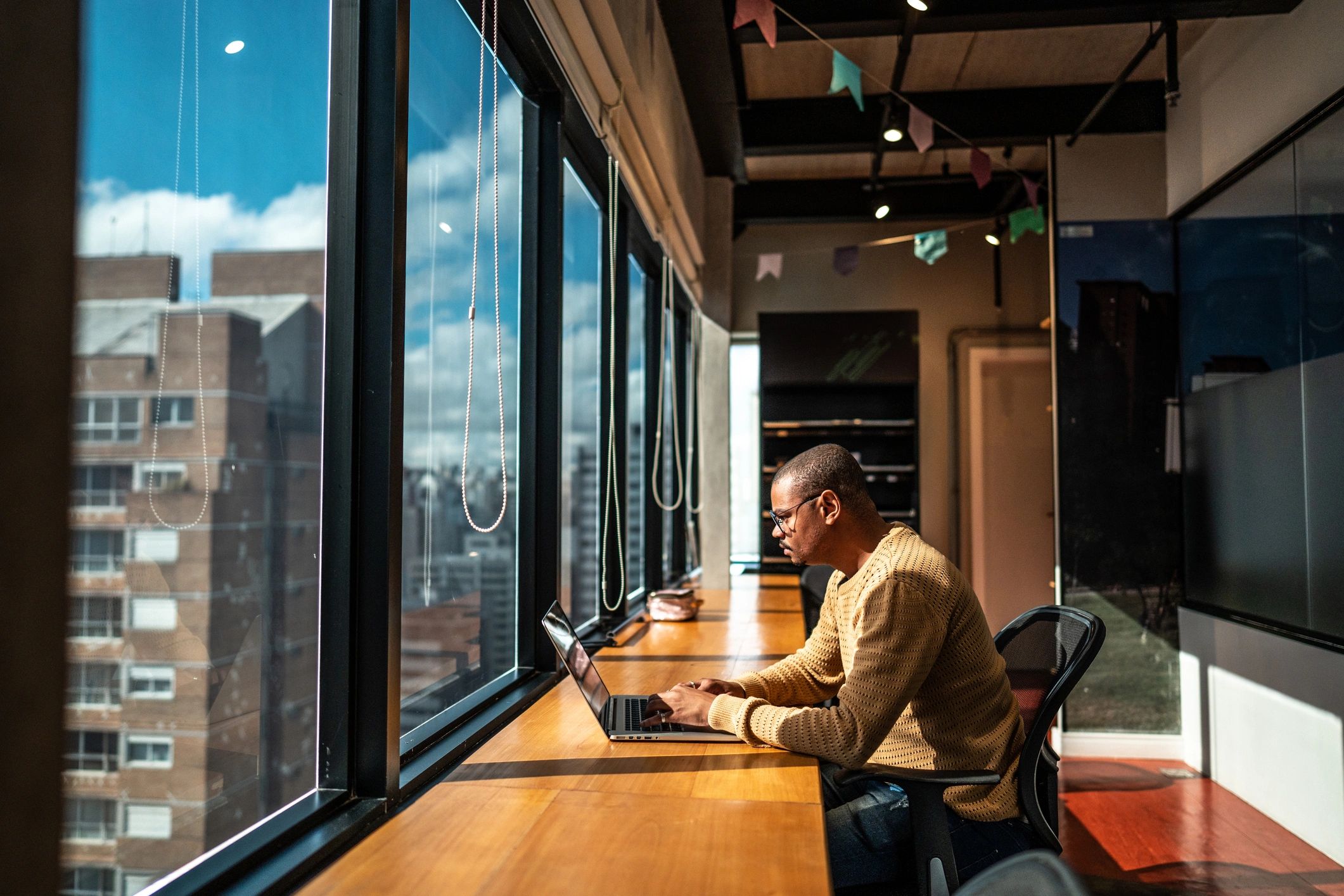 Researcher working on a laptop in a dark office environment