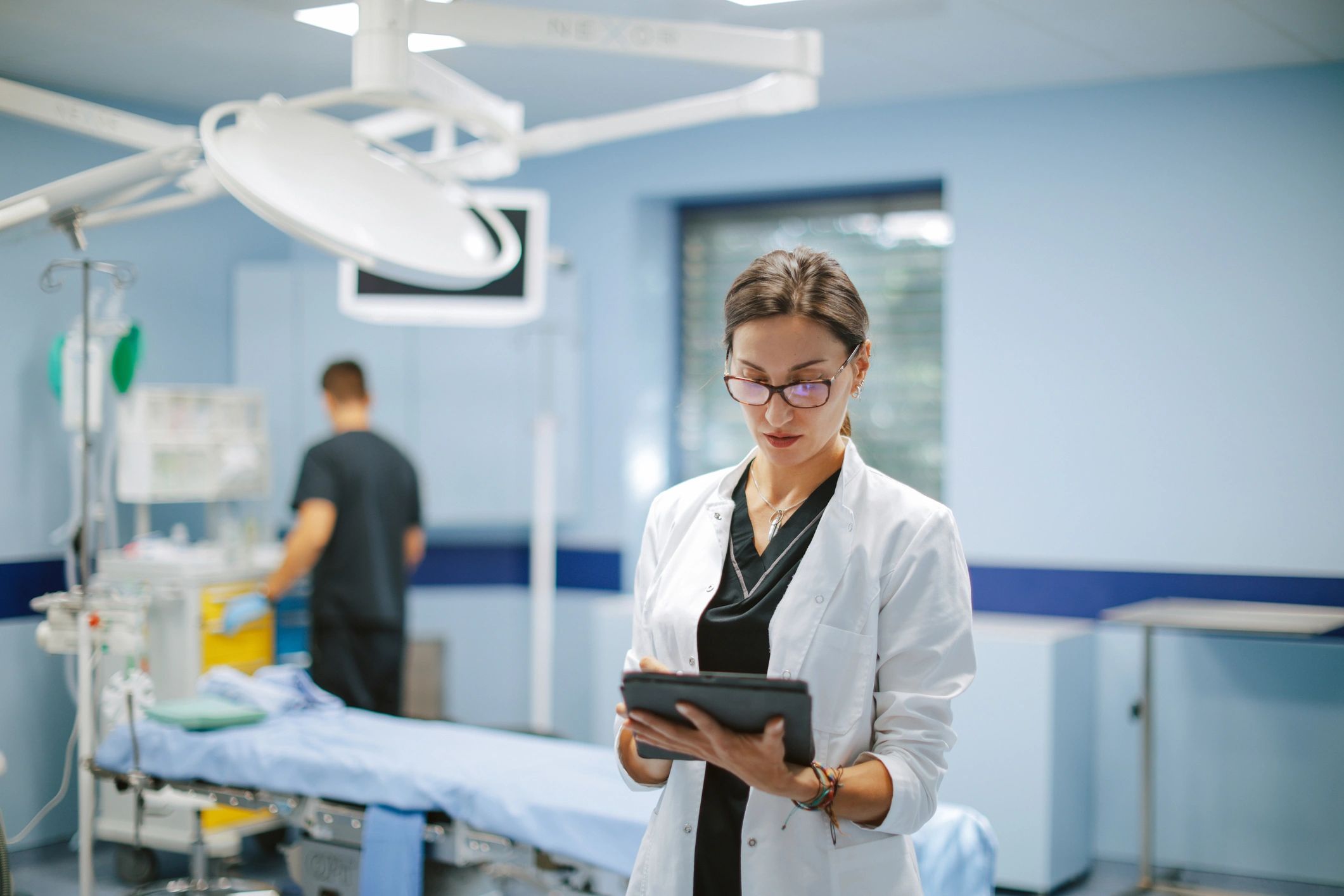 Doctor reviewing data on a digital tablet in a hospital